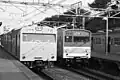 JNR 103 and 205 series Yamanote Line meet at Uguisudani station, February 1986.
