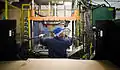 Trim Operator Roger Brown uses robotic presses and computer-controlled machines to produce high-pressure aluminum die-cast automotive components at Port City Group in Muskegon, Michigan.