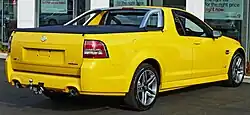Front-three-quarters view of a yellow coupe utility