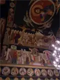 View of Panayia Yiatrissa's “Christ Pantocrator” icon and arched ceiling/wall iconography of the main chapel.