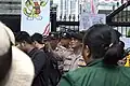 A Medan Police officer taking a picture during protests