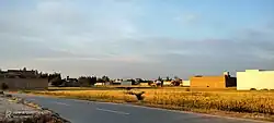 A rural bypass road cutting through golden fields near Hund.