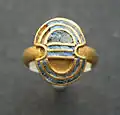 Gold finger ring with lapis lazuli inlays in the shape of a double axe