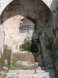 You can find a spring water outlet below ground level.