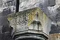 Capital in the gavit with cross carvings