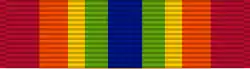 Width-44 ribbon with width-6 central ultramarine blue stripe, flanked by pairs of stripes that are respectively width-4 emerald, width-3 golden yellow, width-5 orange, and width-7 scarlet