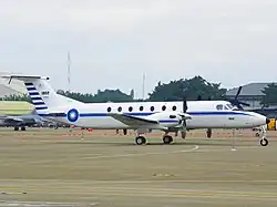 A parked blue and white propeller aircraft