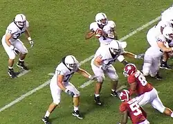 A quarterback drops back to pass.
