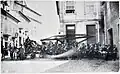 Firefighters posing next to the MSS headquarters (right), in the area where its new façade would soon be built, circa 1900