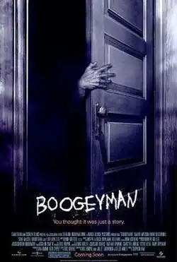 A pale hand sticks out from inside a dark closet.