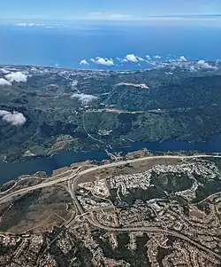 View directed west near interchange with I-280, showing Crystal Springs Reservoir and route from San Mateo to Half Moon Bay