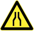Road narrows on both sides