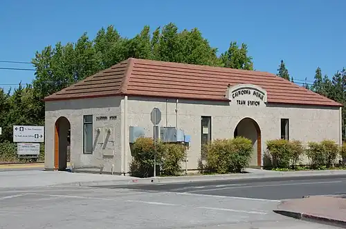 A small gray railroad station building