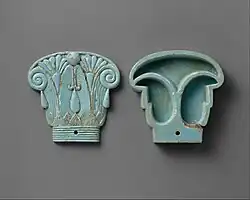 Cosmetic box in the shape of an Egyptian composite capital, its cap being in the left side; 664–300&nbsp;BC; glassy faience; 8.5 × 9&nbsp;cm; Metropolitan Museum of Art