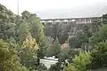 Crystal Springs Dam and Crystal Springs Pump Station, viewed from downstream.