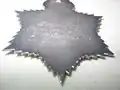 Back of the medal showing Raja's name and award date engraved