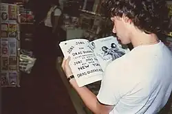 Man reading a book in a store