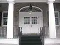 A federal fan-style window in the entrance of Frontier House.