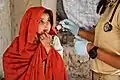 An Afghan girl receiving treatment from an American medic in Oruzgan Province