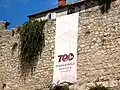 Flag on the city walls dedicated to the seven hundredth anniversary of the birth of Marco Polo