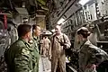 A U.S. staff sergeant gives a safety briefing to two Turkish Air Force UH-60 Black Hawk helicopter pilots