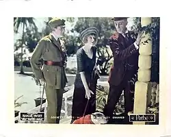 Black and white promotional lobby card showing multiple figures in 1920s dress