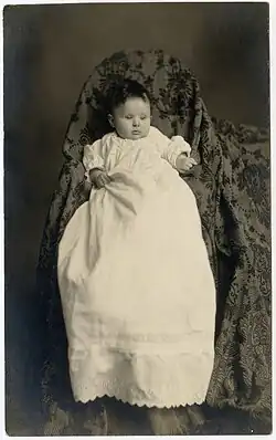 Mother's shape and outline completely hidden by blanket and chair