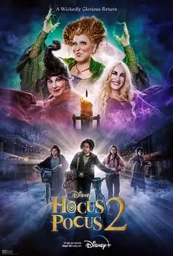 Three witches dressed in bright colors, at the top of the poster. Beneath are three girls, two wheeling bicycles.