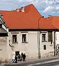 South elevation of the east wing of the house with a picture of the Virgin Mary and a plaque dedicated to Stanisław Wyspiański