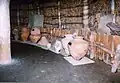 Inside reconstructed pit dwelling with examples of Onga River type Yayoi pottery