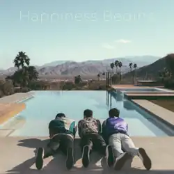The three brothers lying on the floor by the poolside, looking forward into the landscape.