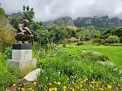 A statue instillation in the garden.