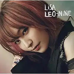 A close-up portrait of Lisa donning red hair and a black dress, with her head slightly tilted towards her right