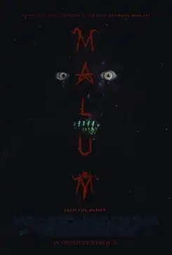 A demon's eyes and teeth are seen in the dark space.