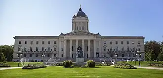 Neoclassical building topped with a cupola and statue