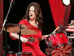 White performing in 2005, looking away from the camera with her eyes closed