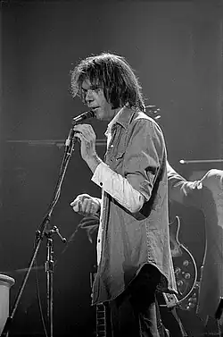 Young standing before a microphone