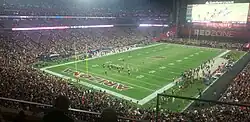 Football field viewed from the stands with the Packers and Cardinals on the field.