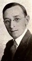 Black and white portrait photograph of a middle-aged man in formal attire