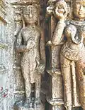 An idol of a Śvetāmbara monk draping a piece of cloth and holding a rajoharana carved on the outer walls of a Jain temple at Pavagadh Hill