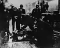 Police officers and fire fighters check for signs of life and collect personal items from victims of the Triangle fire.