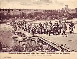Russian prisoners of war led by German soldiers after the surrender of the Novogeorgievsk fortress, August 1915.