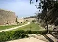 The Tower of Italy had a round bulwark built around by Grand Master Fabrizio del Carretto in 1515–1517, and provided with gun ports at the lowest level covering the ditch in every direction, for a total of three stacked tiers of cannon fire (two from the bulwark, one from the tower).