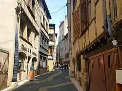 Photograph of a street bordered on both sides by buildings.