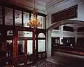 Entrance hall with inscription that reads "Who Earns Money Is God's Beloved"[43]