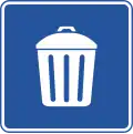Garbage can - road sign in Central America