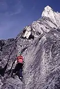 A climber leading one of the early moderate pitches