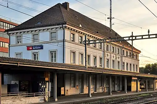 Three-story building with half-hipped roof