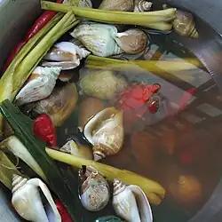 A dish with conch, herbs and vegetables