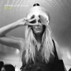 A blurred black-and-white photo of a woman flashing a peace sign
